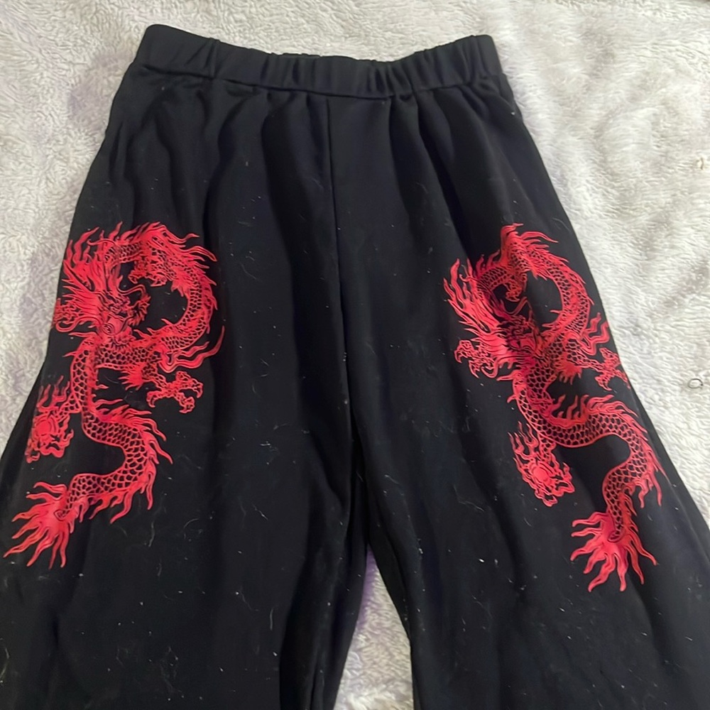 Black sweatpants with red dragons